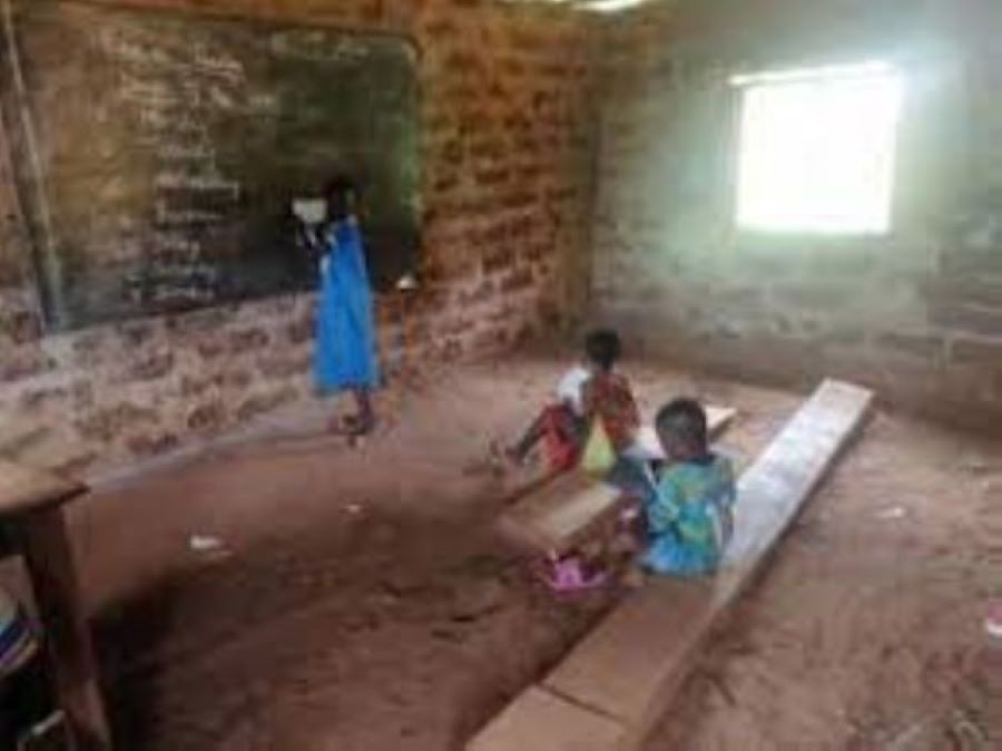 Benue State Community children learn in school sitting on planks