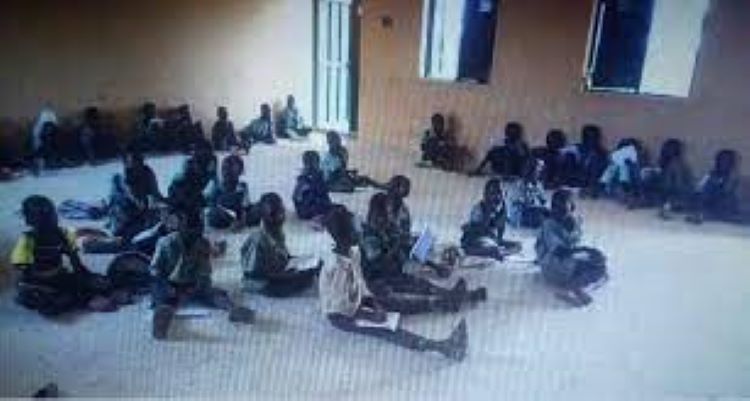FCT School Children learn sitting on floor