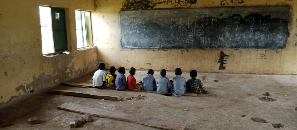 FCT community school kids learn sitting on ground