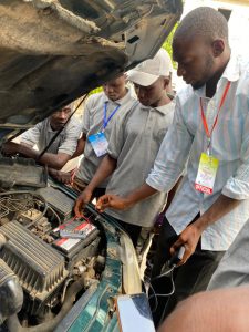 Participants learning how to repair cars 